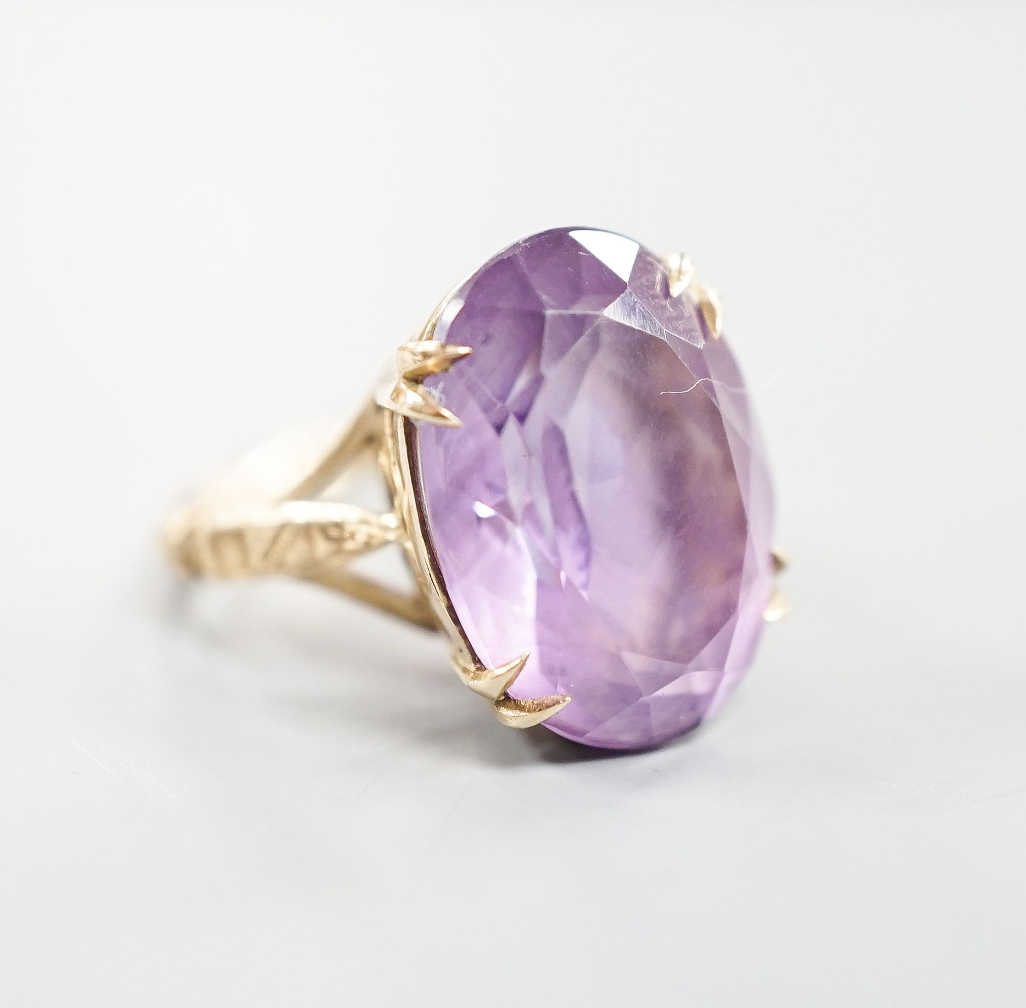 A modern 9ct gold and oval cut amethyst set dress ring, size L/M, gross weight 5.7 grams.